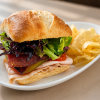 Gobble Gobble On A Garden turkey pesto sandwich on ciabatta with kettle chips for fast beach food delivery in Naples Florida