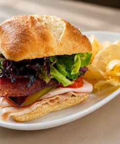 Gobble Gobble On A Garden turkey pesto sandwich on ciabatta with kettle chips for fast beach food delivery in Naples Florida