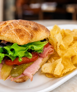 Hamming It Up deli ham sandwich on ciabatta with kettle chips for fast beach food delivery in Naples Florida