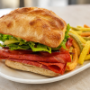 Piccanti Amichetto Italian salami sandwich on ciabatta with kettle chips for fast beach food delivery in Naples Florida