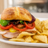 Quarrel In The Coop turkey and chicken sandwich on ciabatta with kettle chips for fast beach food delivery in Naples Florida