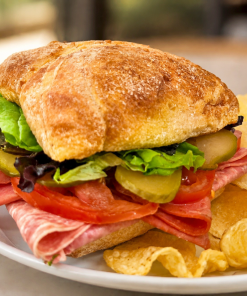 Saludos Desde La Habana Cuban salami sandwich on ciabatta with kettle chips for fast beach food delivery in Naples Florida