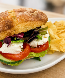 Welcome To The Funny Farm avocado and goat cheese sandwich on ciabatta with kettle chips for fast beach food delivery in Naples Florida