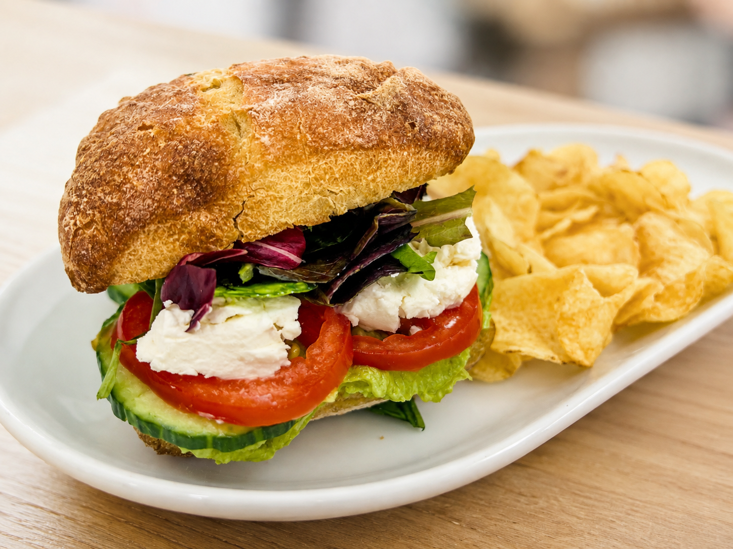 Welcome To The Funny Farm avocado and goat cheese sandwich on ciabatta with kettle chips for fast beach food delivery in Naples Florida