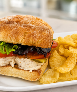 White Smokey Os smoked white fish salad sandwich on ciabatta with kettle chips for fast beach food delivery in Naples Florida